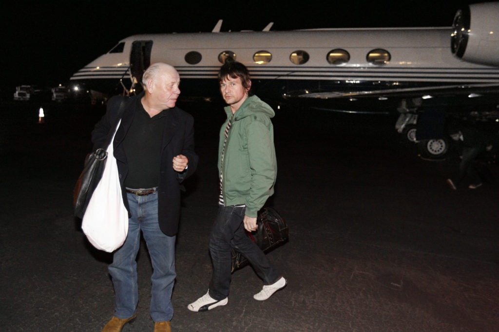 The Who's onstage sound engineer Bob Pridden and drummer Zak Starkey head to their cars after exiting their plane in Denver, CO.
